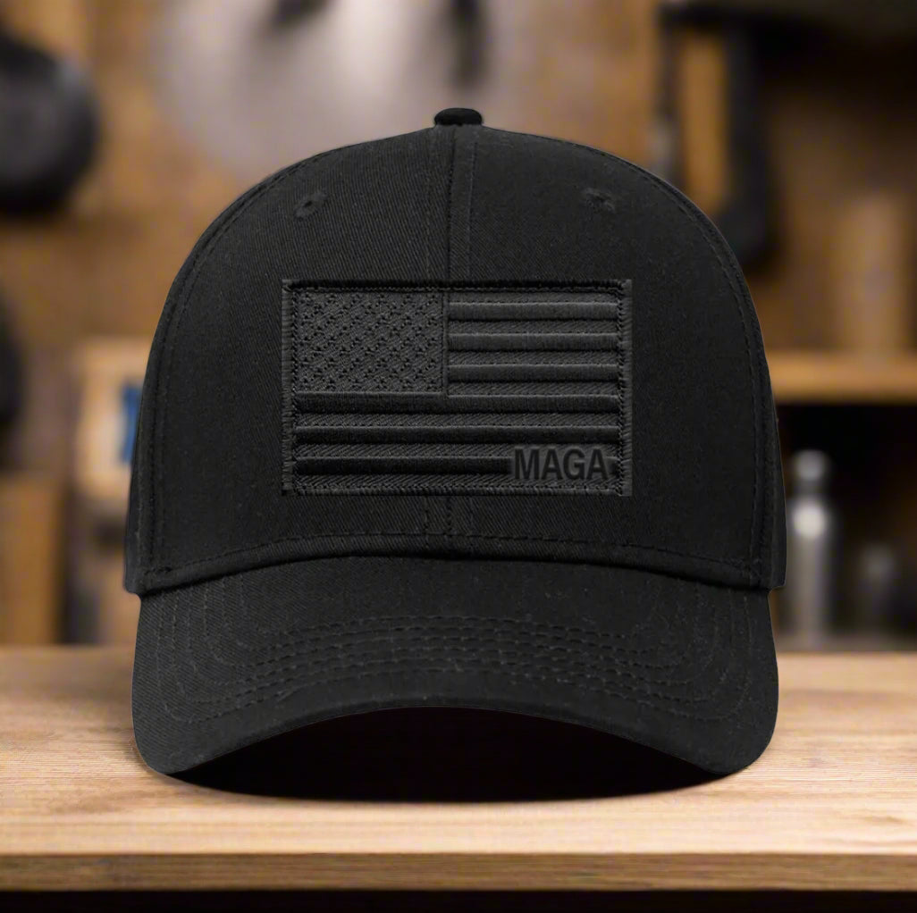 Black cap with American flag and 'MAGA' text on a white background