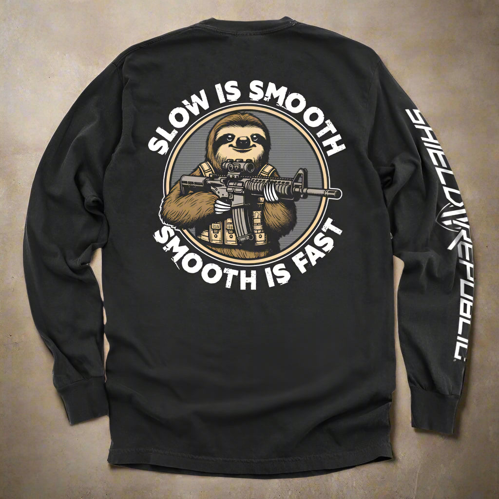 Black long-sleeve shirt with a sloth holding a rifle graphic and text 'Slow is Smooth, Smooth is Fast' on a white background.
