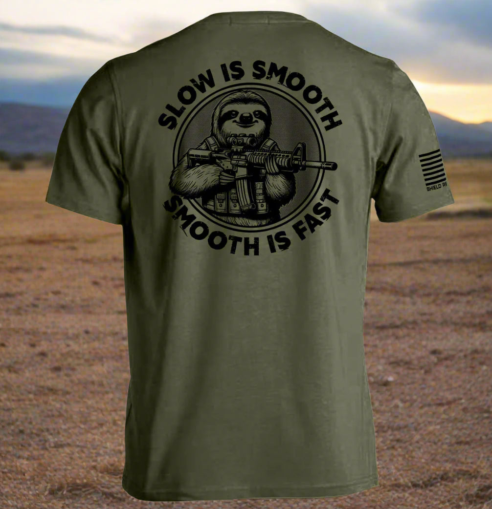 Military green t-shirt with a graphic of a sloth holding a rifle and text 'Slow is Smooth, Smooth is Fast' on the back.