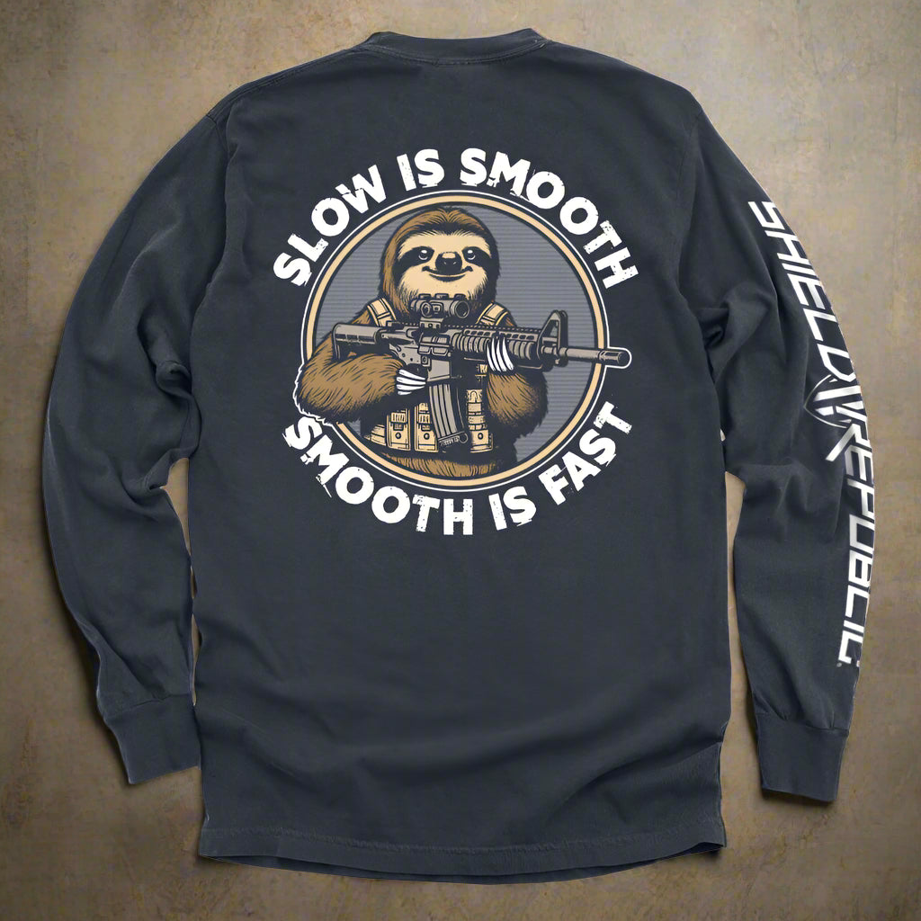 Navy long-sleeve shirt with a graphic of a sloth holding a rifle and text 'Slow is Smooth, Smooth is Fast' on the back.