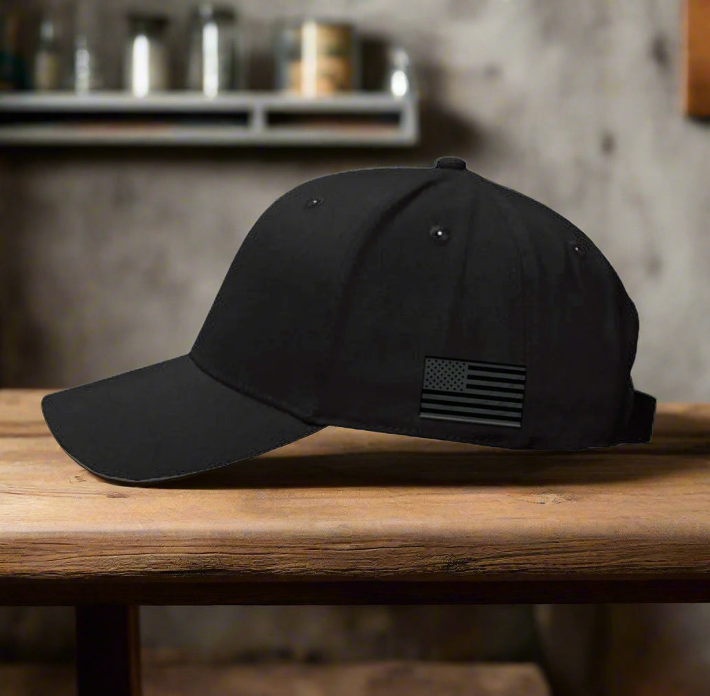 Black baseball cap with American flag patch on a white background