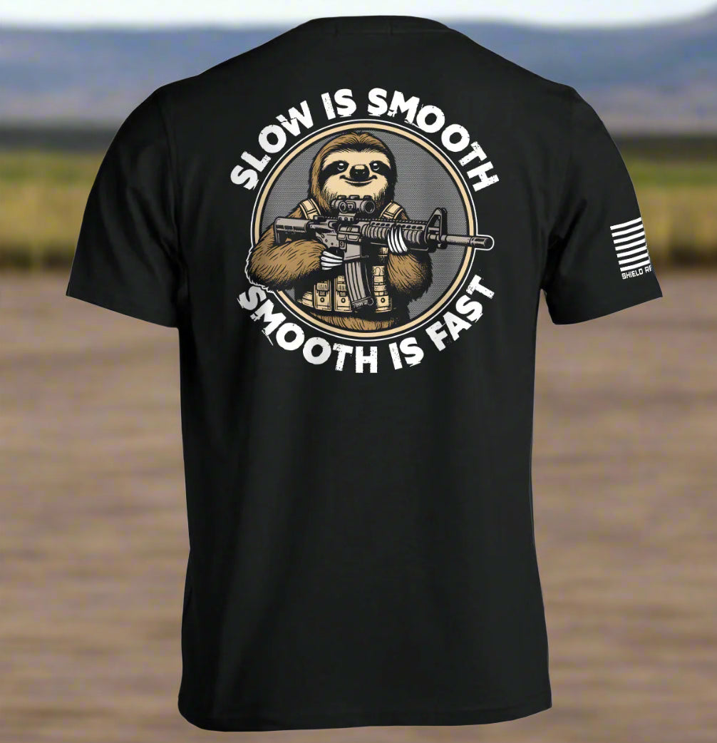 Black t-shirt with a graphic of a sloth holding a rifle and text 'Slow is Smooth, Smooth is Fast' on the back.
